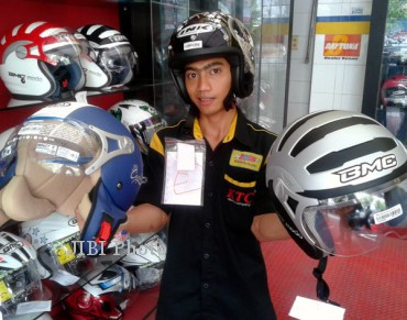 Seorang pegawai bagian pemasaran MOSS Jl Slamet Riyadi Solo, Imam, menunjukkan beberapa jenis helm klasik, belum lama ini. Helm berdesain retro kembali menjadi primadona. (Kurniawan/JIBI/SOLOPOS)