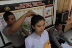Seorang anggota Kepolisian Negara Republik Indonesia (Polri) mengukur tinggi badan seorang perempuan yang melamar menjadi calon Bintara Brigadir Wilayah Solo di Mapolresta Solo, Minggu (20/4/2014). Seleksi calon bintara di Kota Solo diikuti oleh 132 pendaftar pria dan 114 pendaftar wanita. (Septian Ade Mahendra/JIBI/Solopos)