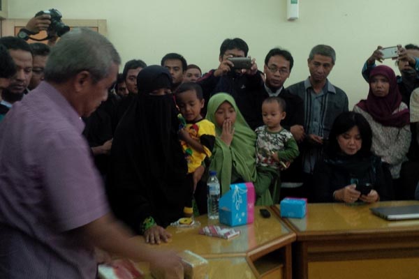 Suratmi (bercadar hitam) saat menitipkan dua gepok uang kerahiman atas kematian suaminya, Siyono, kepada PP Muhammadiyah, Selasa (29/3/2016). (Ujang Hasanudin/JIBI/Harian Jogja)