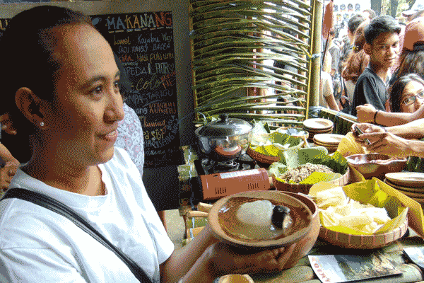 Salah seorang mahasiswa asal Maluku memperlihatkan Papeda dan Ikan Kuah Air Garam makanan khasnya dalam acara Icip-icip IICF, Rabu (20/4).