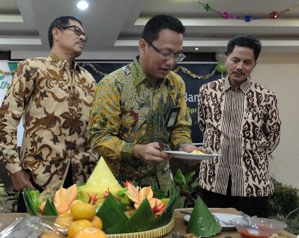 Pimpinan PT Pegadaian (Persero) Wilayah IX Semarang Damar Lastri Setiawan memotong tumpeng pada syukuran HUT ke-115 Pegadaian di Kantor Pegadaian Wilayah IX Semarang Jl. Ki Mangunsarkoro, Semarang, Jumat (1/4/2016). (Insetyonoto/JIBI/Solopos)