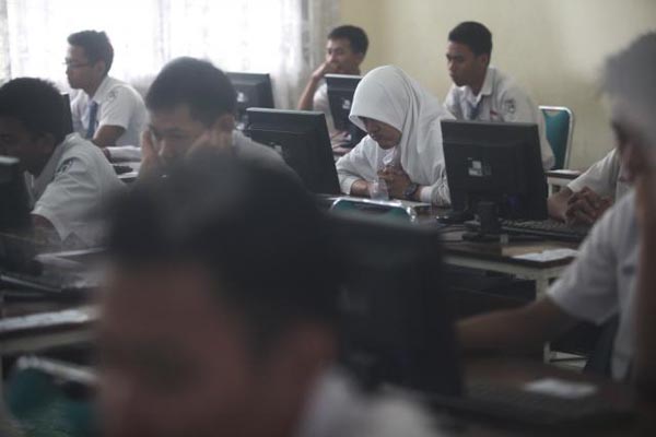 Siswa SMK Negeri 2 Solo mengerjakan soal menggunakan komputer saat mengikuti Ujian Nasional (UN) hari pertama berbasis komputer atau Computer Based Test (CBT) di SMK Negeri 2 Solo, Senin (13/4). Pelaksanaan UN CBT untuk siswa SMA/SMK sederajat di Kota Solo pada hari pertama berjalan lancar tanpa ada gangguan tekhnis.
