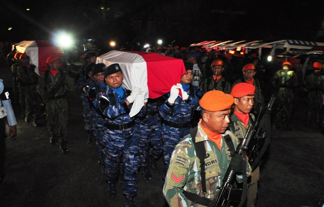 Prajurit TNI AU menggotong peti jenazah korban kecelakaan pesawat Hercules A-1334 untuk disemayamkan di Hanggar Skadron 32 Lanud Abdulrahman Saleh, Malang, Jawa Timur, Minggu (18/12/2016) malam. Kecelakaan pesawat milik TNI AU di Wamena Papua tersebut menewaskan 12 kru dan satu orang penumpang. (JIBI/Solopos/Antara/Renny K.)