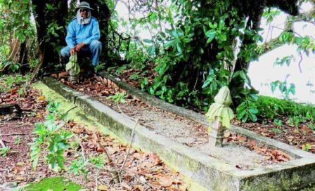 Sejarawan Azman Wahab berdiri di pinggir makam raksasa yang ditemukan di Pulau Upeh (The Star)