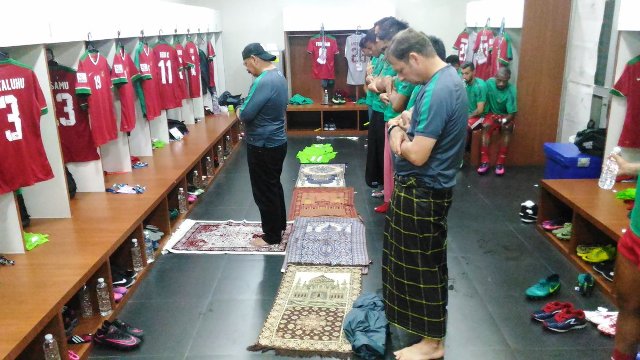 Pemain dan staf pelatih Timnas Indonesia melakukan salat magrib berjamaah di ruang ganti Stadion Rajamangala, Bangkok, Thailand, Sabtu (17/12/2016). (Twitter @pssi_fai)