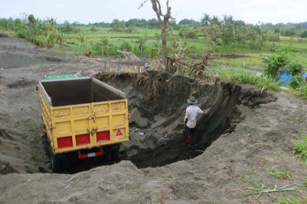 Sebuah truk tengah menunggu giliran pengisian pasir dari lokasi penambangan ilegal di sisi selatan JJLS, tepatnya di Dusun Ngepet Desa Srigading, Kecamatan Sanden, Kamis (9/2) sore. (Harian Jogja/Arief Junianto)