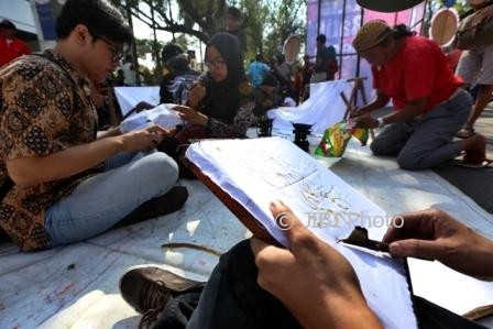 Warga menyelesaikan pembuatan batik tulis saat car free day (CFD), Jl. Slamet Riyadi, Solo, Minggu (1/10/2017). (Nicolous Irawan/JIBI/Solopos)