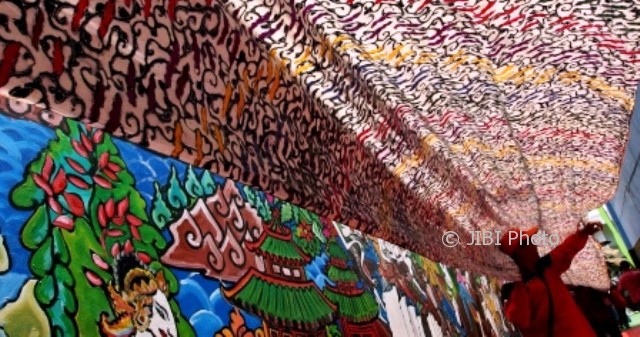 Warga membentangkan 33 m kain batik bermotif parang asem arang saat memperingati Hari Batik Nasional di Kampung Batik Semarang, Jateng, Senin (2/10/2017). (JIBI/Solopos/Antara/R. Rekotomo)
