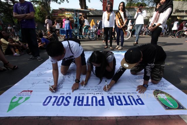 Warga menuliskan pesan dan harapan dalam Putra Putri Solo 2017 Road to Mas Mbak Jateng 2017 di car free day (CFD) Jl. Slamet Riyadi, Solo, Minggu (8/10/2017). (M. Ferri Setiawan/JIBI/Solopos)