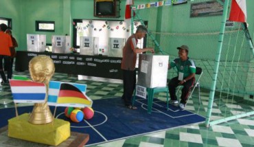 Warga memasukkan surat suara ke kotak suara di Tempat Pemungutan Suara (TPS) 5, Ponggalan, Giwangan, Kota Yogyakarta, Rabu (9/7/2014). TPS Pemilu Presiden dan Wakil Presiden (Pilpres) 2014 tampak unik dengan dekorasi Piala Dunia 2014, bahkan dilengkapi dengan lapangan mini lengkap dengan gawang. Seluruh petugas pemilihan presiden mengenakan jersey negara peserta Piala Dunia 2014. (Desi Suryanto / JIBI / Jogja Daily) Pendaftaran PTPS