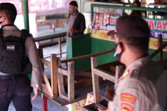 Tim gabungan membantu membalik meja kursi di warung kawasan Selter Kuliner Manahan Solo yang masih melayani makan di tempat ppkm darurat