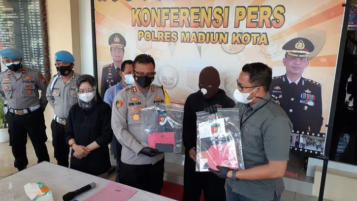 Kapolres Madiun Kota, AKBP Dewa Putu Eka Darmawan, menunjukkan barang bukti kasus pelanggaran UU ITE terkait penghinaan profesi wartawan di Facebook, Kamis (29/7/2021). (Solopos.com/Abdul Jalil)