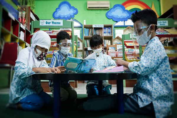 Anak-anak Early Years-Primary Years Programme (TK) sedang asyik membaca buku di perpustakaan dalam kegiatan Eksplorasi Pustaka. (Istimewa)