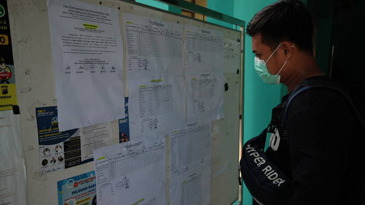 Warga melihat pengumuman daftar peringkat seleksi perangkat desa di Balai Desa Gabus, Kecamatan Ngrampal, Sragen, Rabu (9/12/2021) sore. (Solopos.com/Wahyu Prakoso)